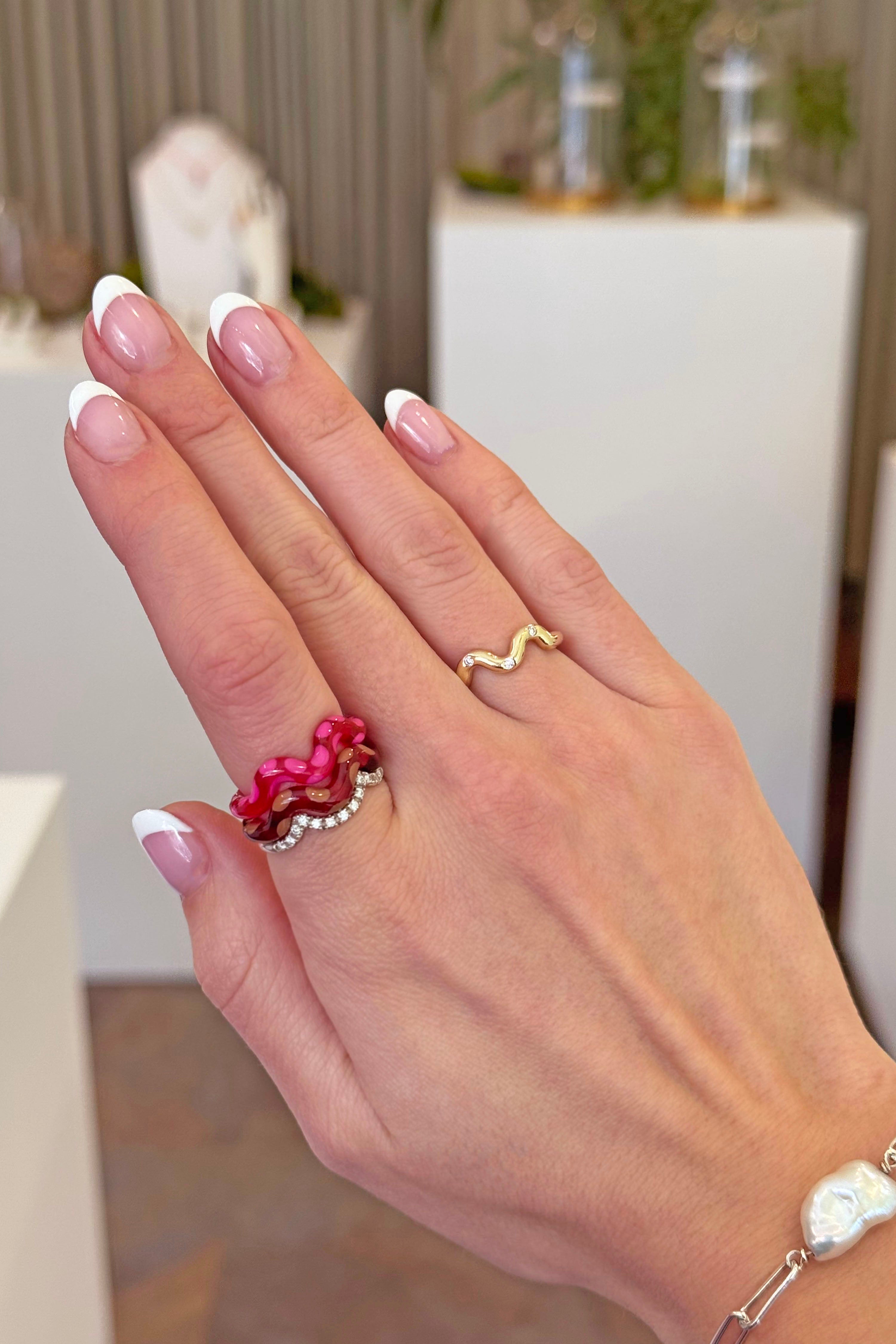 A hand model wearing the single wave raspberry ring. Charm are 3D printed and hand finished. Made in New York. 