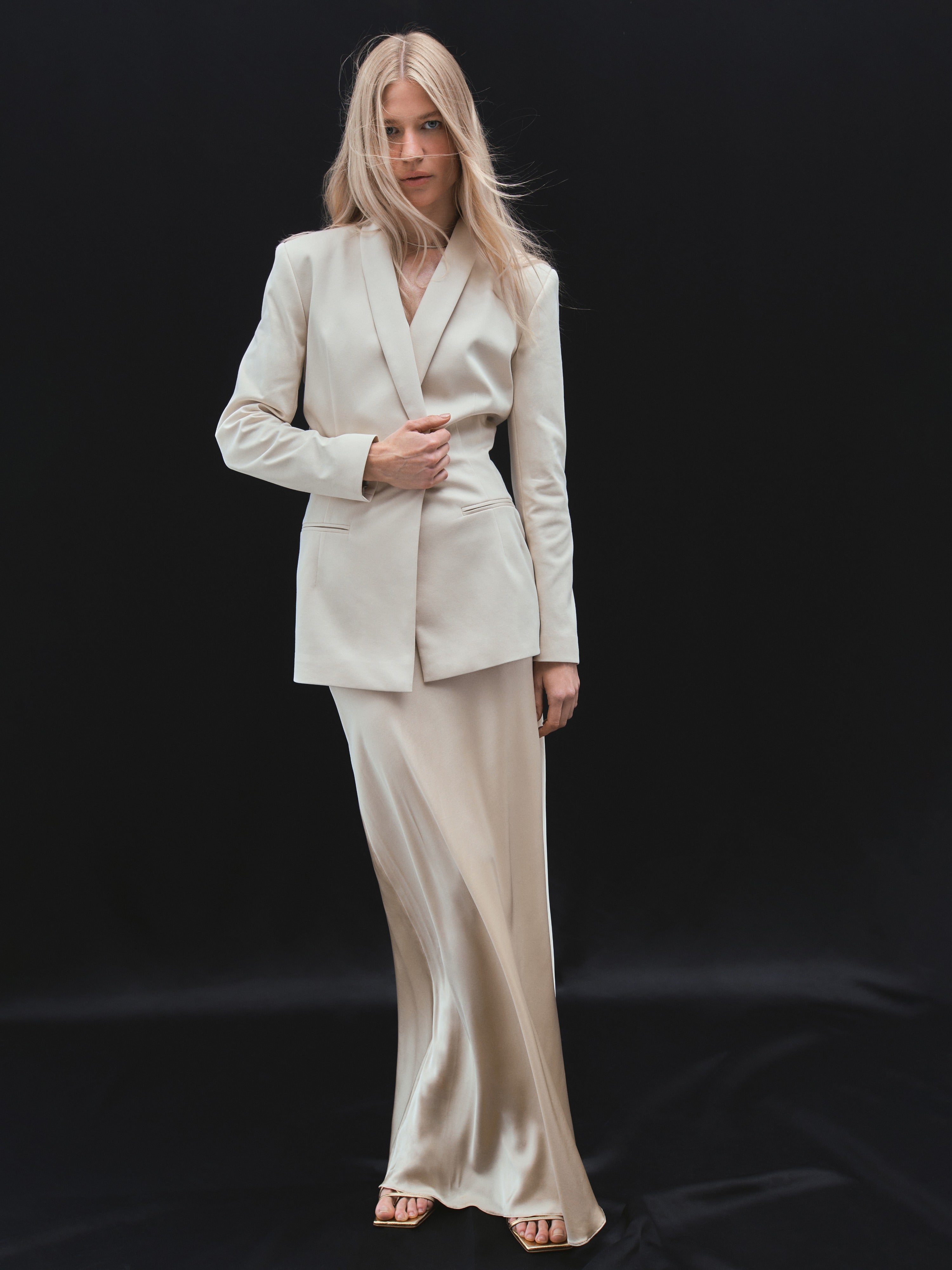 A model wearing the brazillian sand siren skirt in a black background. 100% made from sustainable silk.